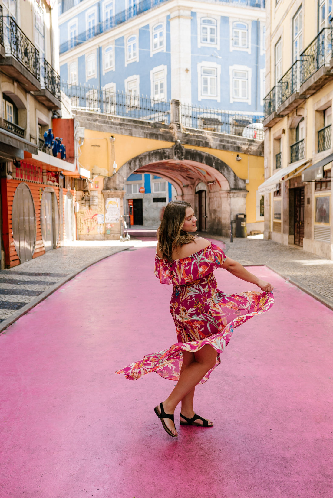 A woman wearing a dress and travel sandals on vacation