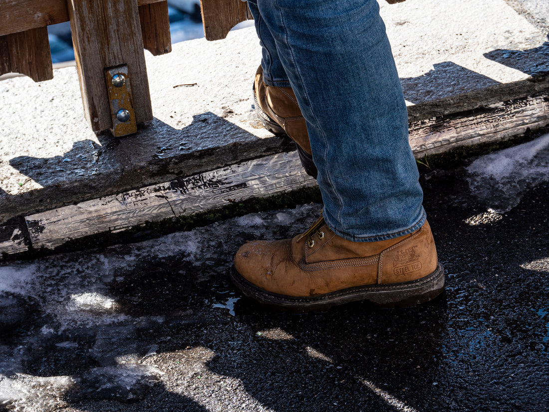 A pair of worn leather work boots