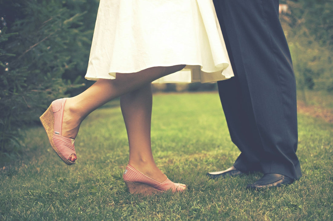 A man’s and woman’s feet on the grass